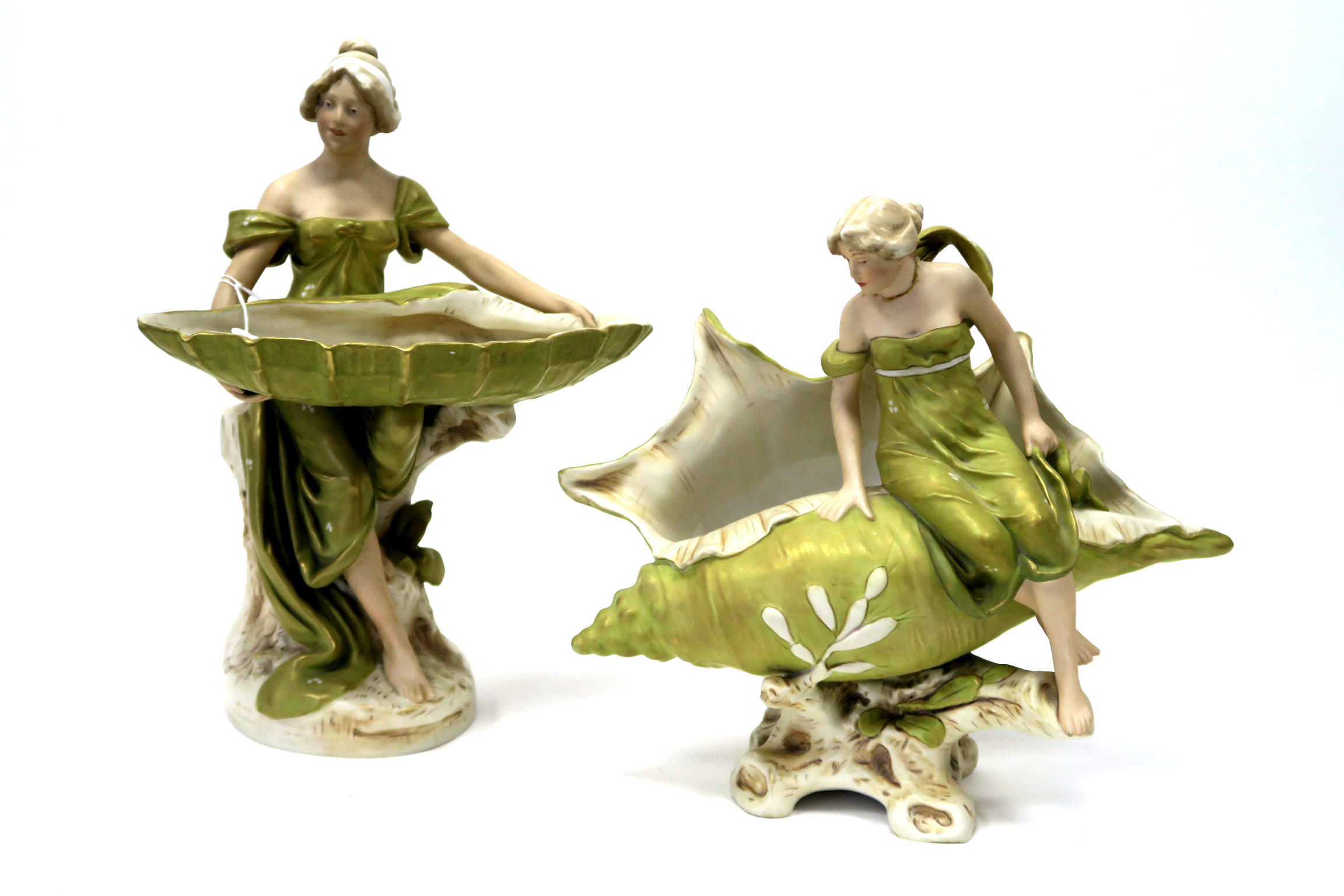 A Royal Dux Pottery Model of a Lady Seated on a Rock Holding a Large Shell, upon a naturalistic oval