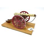 A Detailed Model of a Napoleonic Era Cannon on Wheels, attached to wooden plinth, 29cm long.