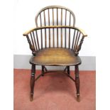 A XIX Century Ash and Elm Windsor Chair, with hooped back, rail supports, on turned legs united by