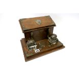 A Late XIX Century Oak Desk Stand, of rectangular form, with two square inkwells with plated mounts,