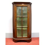 A XX Century Walnut Floor Standing Corner Cupboard, with stepped pediment, glazed door with three