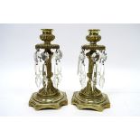 A Pair of Mid XX Century Continental Brass Candlesticks, each with faceted lustre drops, acanthus