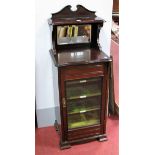 An Early XX Century Mahogany Music Cabinet, top with a swan neck pediment, upper shelf with a