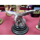 A Car Mascot, as an eagle with wings outstretched, in a chromed metal on circular base, 23.5cm wide,