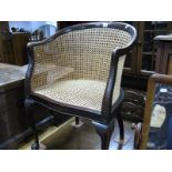 Early XX Century Mahogany Bergere Tub Chair, with a gadrooned edge, shaped arms, carved back and