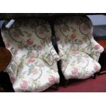 A Pair of French Style Armchairs, upholstered in a floral fabric, on cabriole legs.