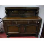 A 1920's Oak Sideboard With cup and cover supports, to low back and base, having three drawers