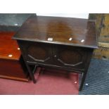 A 1920's Oak Smokers Cabinet, having octagonal symmetrical motifs to twin drawers.