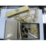 Two Late XIX Century Graduated Ivory Bead Necklaces, a Chinese carved ivory and faceted black bead