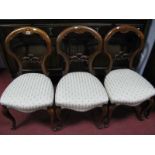 A XIX Century Three Walnut Chairs, with pierced centre rail, upholstered seats, on cabriole legs.