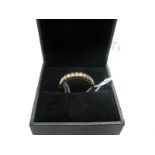 A Nine Stone Diamond Set Half Eternity Style Ring, uniform set throughout, stamped "750".