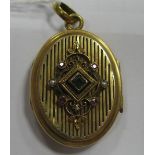 A XIX Century Style Oval Locket Pendant, with raised collet set detail to the front.