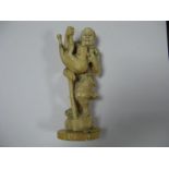 A Late XIX Century Japanese Ivory Figure of a Gentleman Carrying a Wolf, standing on an axe