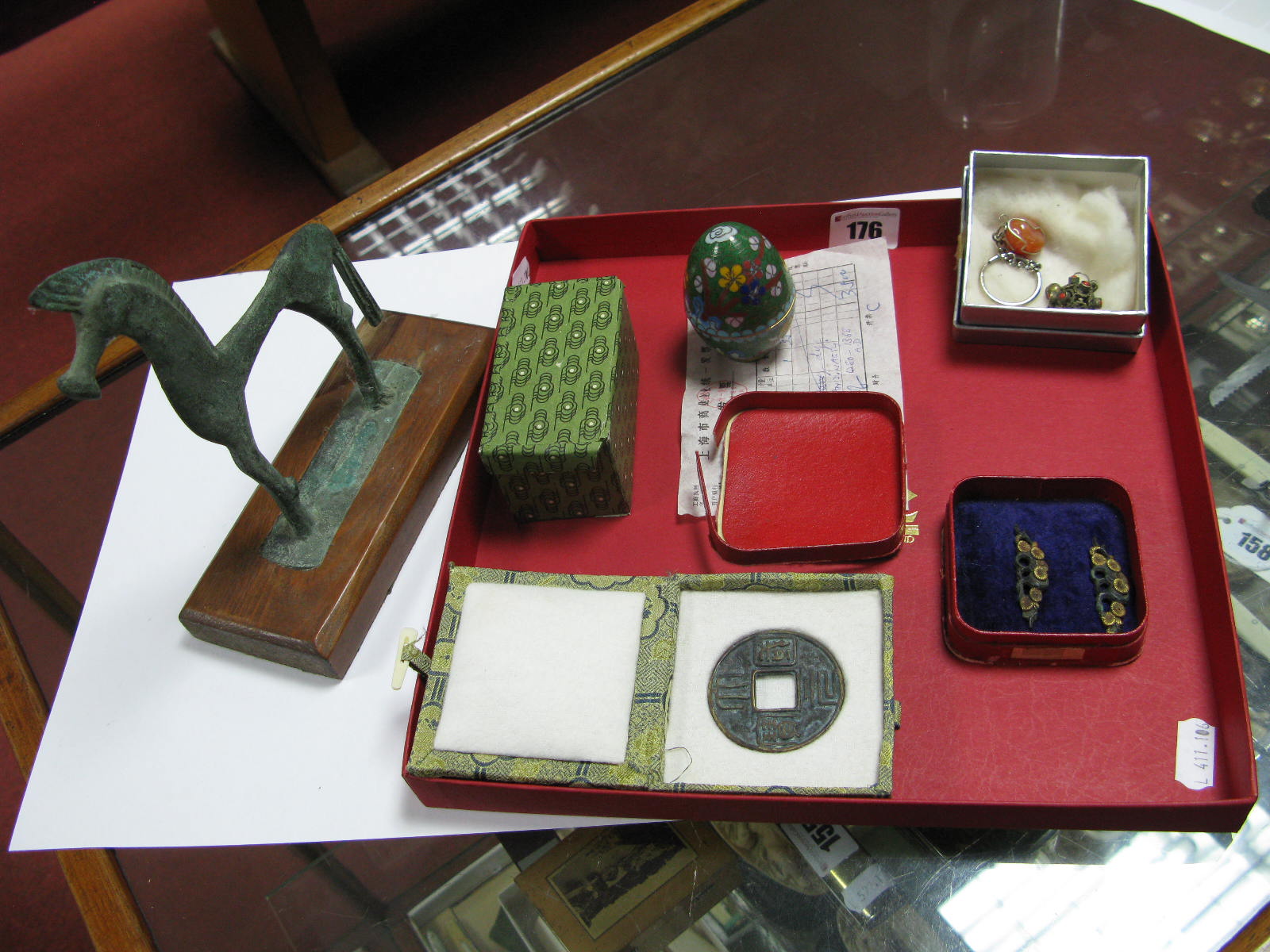 A Chinese Bronze Tsuba Cast with Characters, in presentation box, a Cloisonné egg the green ground