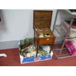 A Small Square Top Sewing Table, with decorative mat glazed top, with assorted contents of patterns,