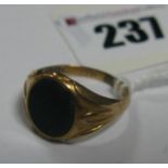 A 9ct Gold Bloodstone Inset Signet Style Ring, between textured shoulders.