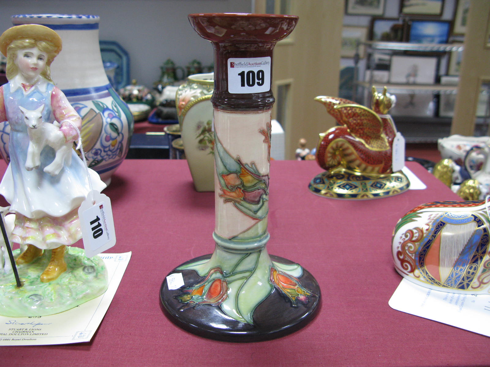 A Moorcroft Pottery Candlestick, tubelined and painted in the Red Tulip pattern against a cream