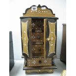 An Asian/Indonesian Four Drawer Jewellery Cabinet, with twin opening doors, richly decorated in