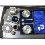 A Pair of Hallmarked Silver Mounted Cut Glass Salts, a plated three piece cruet and a cased pair