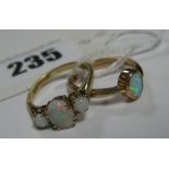 A 9ct Gold Three Stone Opal Ring, oval claw set to the centre, between two circular cabochon