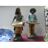 A Pair of Early XX Century Austrian Terracotta Figures, modelled as Moorish basket sellers in