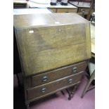 Oak Bureau, circa 1930's, with fall front over two drawers, on turned and block supports, bearing