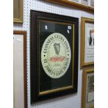 A Reproduction Guinness Mirror, framed Guinness beer mats, framed Guinness poster of a toucan,