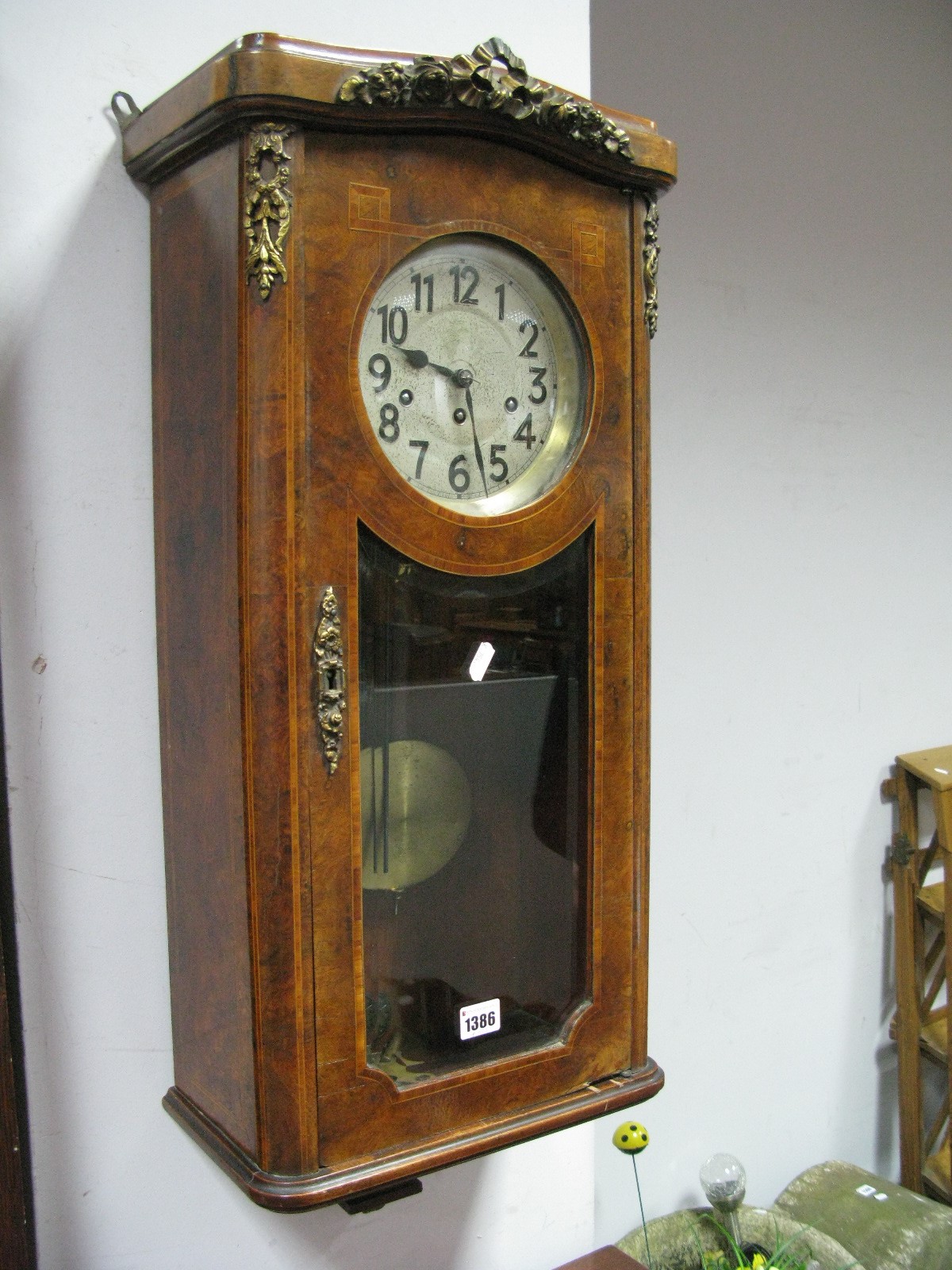 A Late XIX Century Wall Clock, with a Junghans movement and a silvered dial with Arabic numerals,