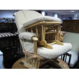 A Mama's & Papas Light Wood Rocking Easy Chair and Foot Stool; together with cane effect child's