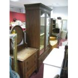 An Early XX Century Walnut Double Wardrobe, having poker work carving to twin mirrored doors on