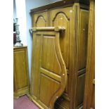 A Modern Pine Armoire, twin handled fielded panel doors over short drawers, reeded and canted