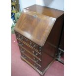 A Reproduction Mahogany Bureau, fall front with gilt green leather scurier over four long drawers,