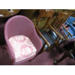 A Lloyd Loom Tub Chair, in pink and a pair of modern armchairs.