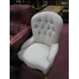 An Upholstered Nursing Chair, on cabriole legs, pad feet.