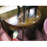 An XVIII Century Mahogany Demi-Lune Table, on tapering legs.