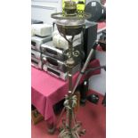 An Early XX Century Wooden Iron Floor Standing Paraffin Lamp. scroll supports and four feet with