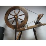 A Stained Hardwood Spinning Wheel, with bobbins and yarm.