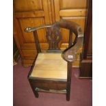 An XVIII Mahogany Corner Chair, having twin pierced splats, pad arms, on block legs.