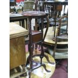 A Reproduction Mahogany Plant Stand, triangular top, moulded edge with trellis work apron, on leaf