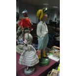 A Plaster Whistling Boy, 58cm high; together with a crinoline lady, (both repaired). (2)