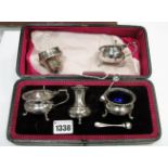 A Hallmarked Silver Three Piece Cruet Set, in a fitted case with associated spoons; together with
