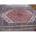 An Iranian (Kashouli?) Fringed Rug, central medallion within interwoven geometric motifs on a red