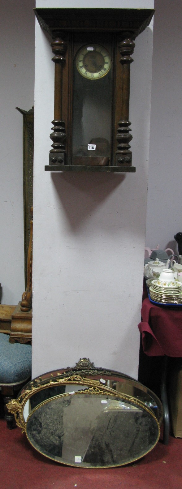 A Circa 1900 Mahogany Cased Vienna Style Wall Clock, (incomplete) and four oval wall mirrors. (5)