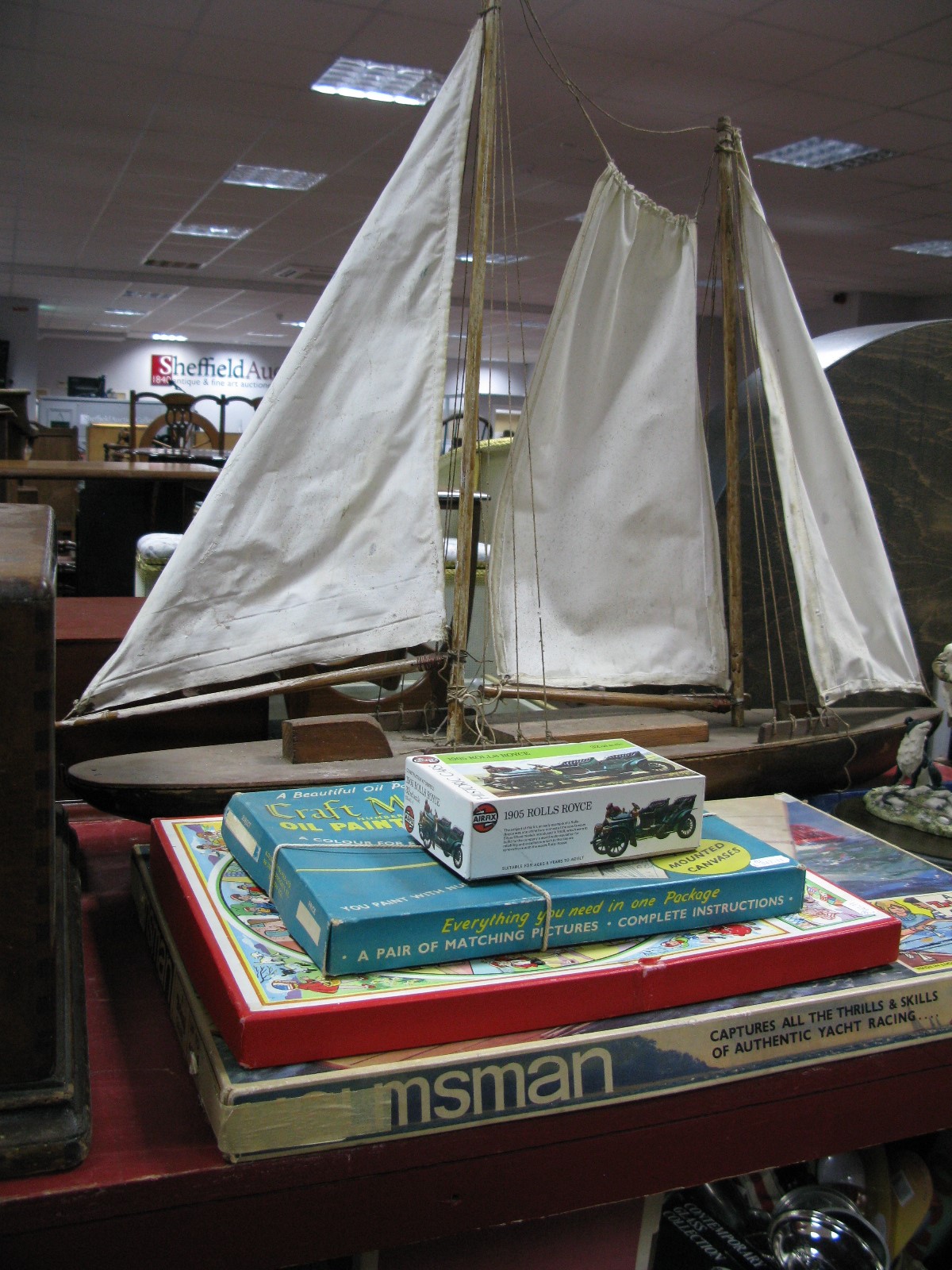 A Child's Wooden Sailing Boat, canvas sails, length 93cm, Triang 'Helmsman' game, Airfix 1905
