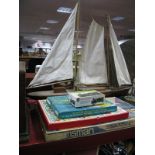 A Child's Wooden Sailing Boat, canvas sails, length 93cm, Triang 'Helmsman' game, Airfix 1905