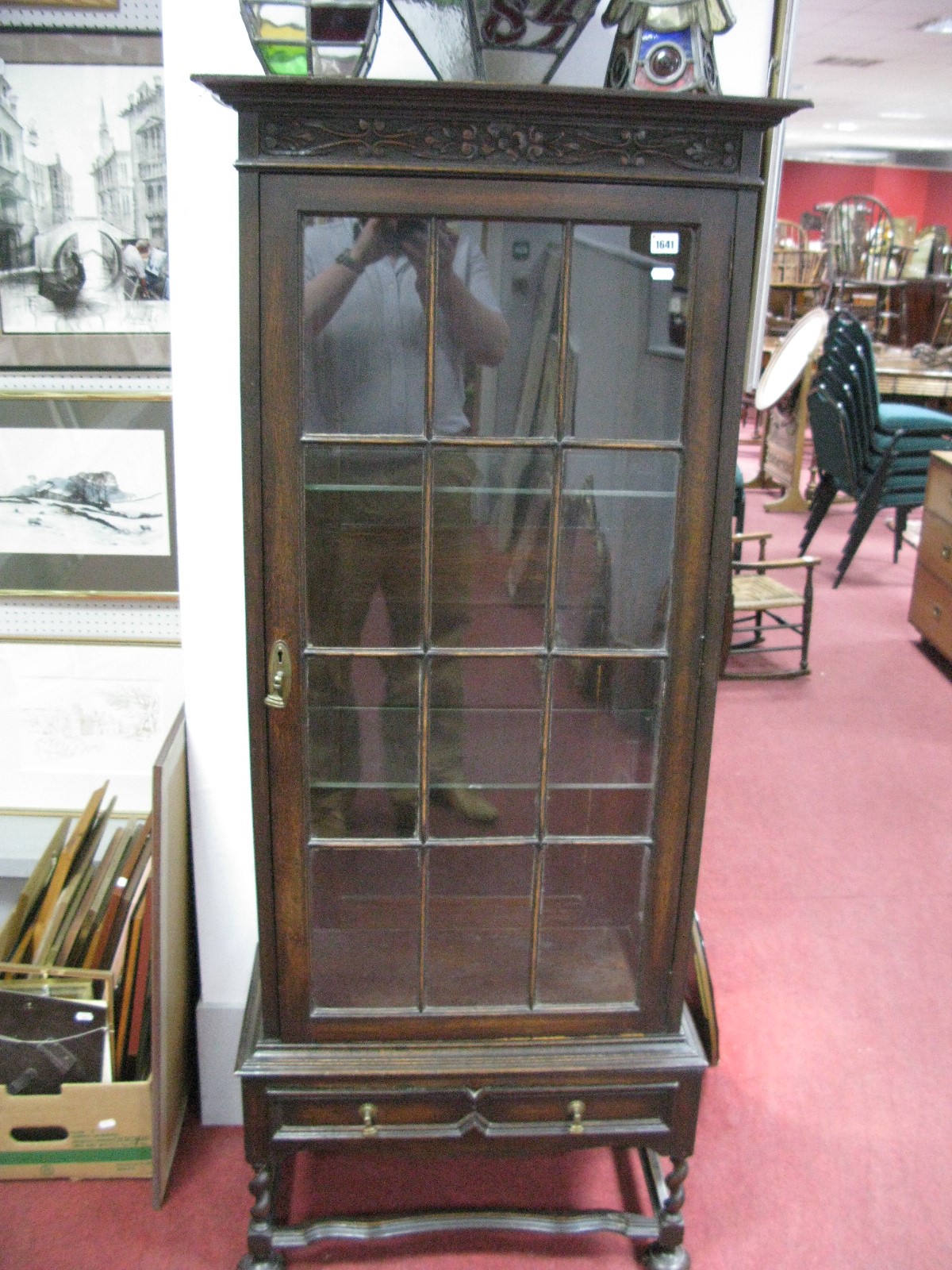 A 1920's Oak Display Cabinet, with carved frieze, glazed door, two internal shelves, single