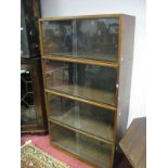 A Simplex Four Heights Sectional Bookcase, each section with sliding glass doors.