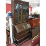 A 1920's Oak Bureau Bookcase, leaded glazed doors over fall front above two long drawers, on