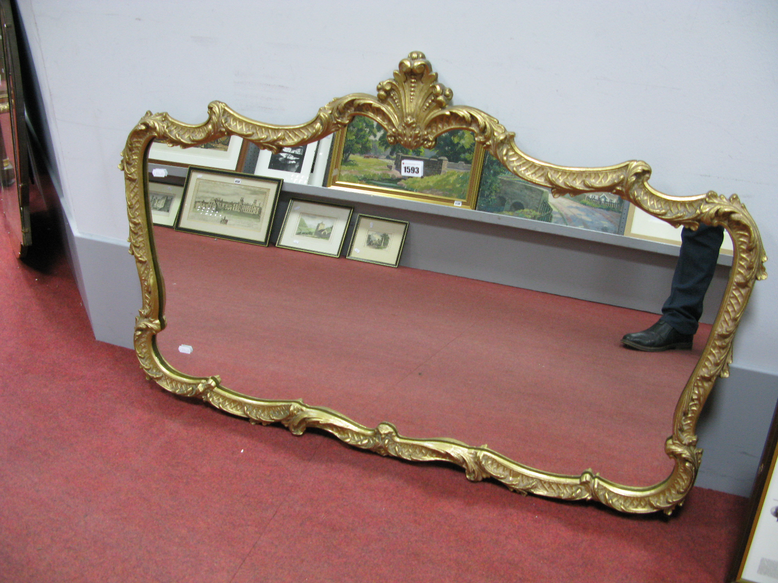 A Gilt Metal Wall Mirror, of shaped rectangular form, scroll and foliate frame with feather