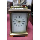 Brass Cased Carriage Clock, with black Roman numerals to white dial, R & C Paris to back plate.